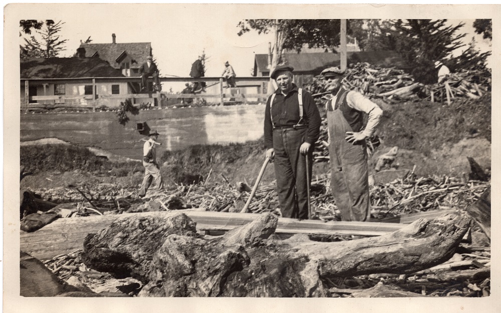 Louis and Conrad Scholl standing among driftwood on Seabright Beach, 1930s.