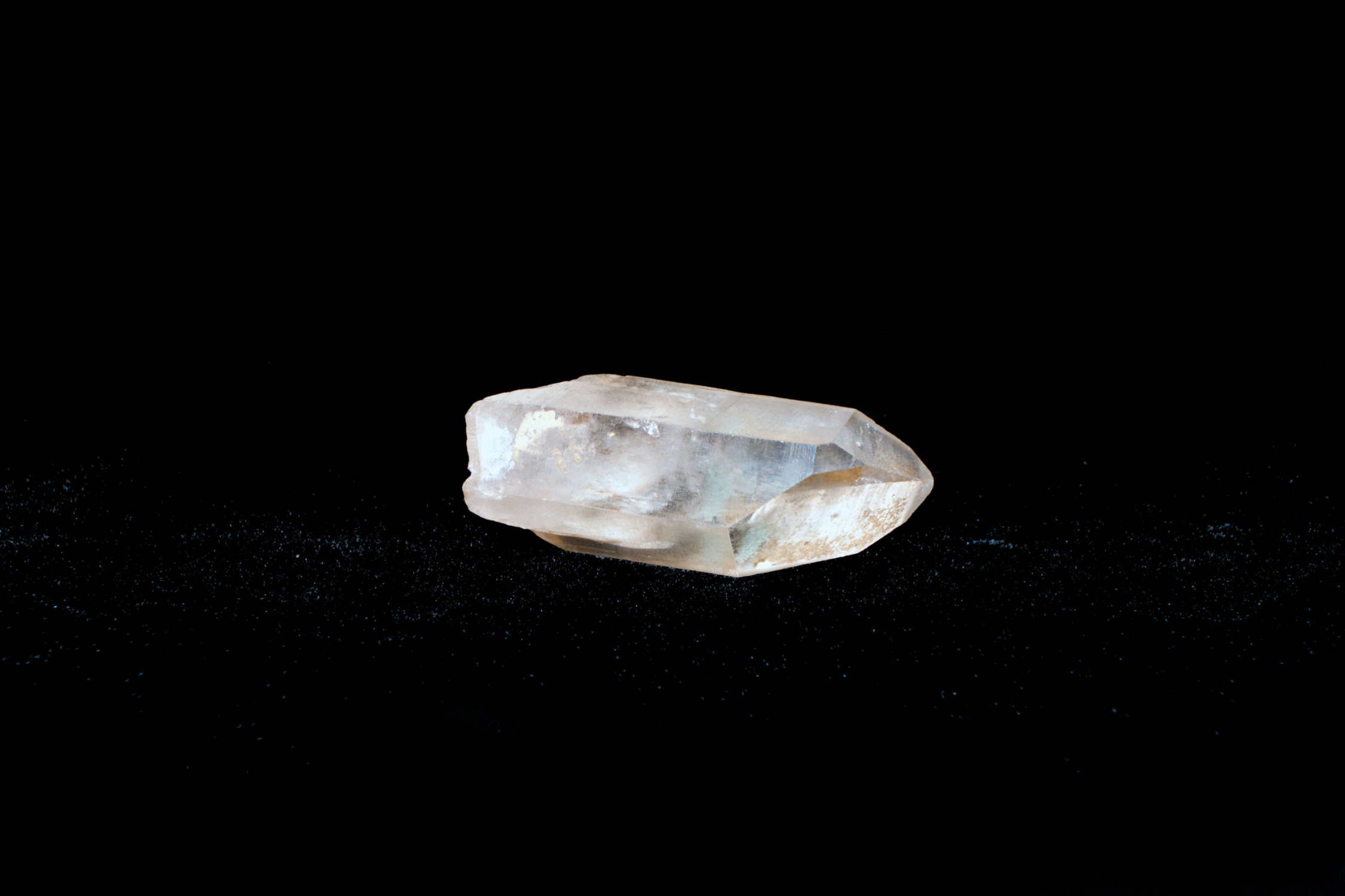 Quartz A small piece of clear quartz on a black background.