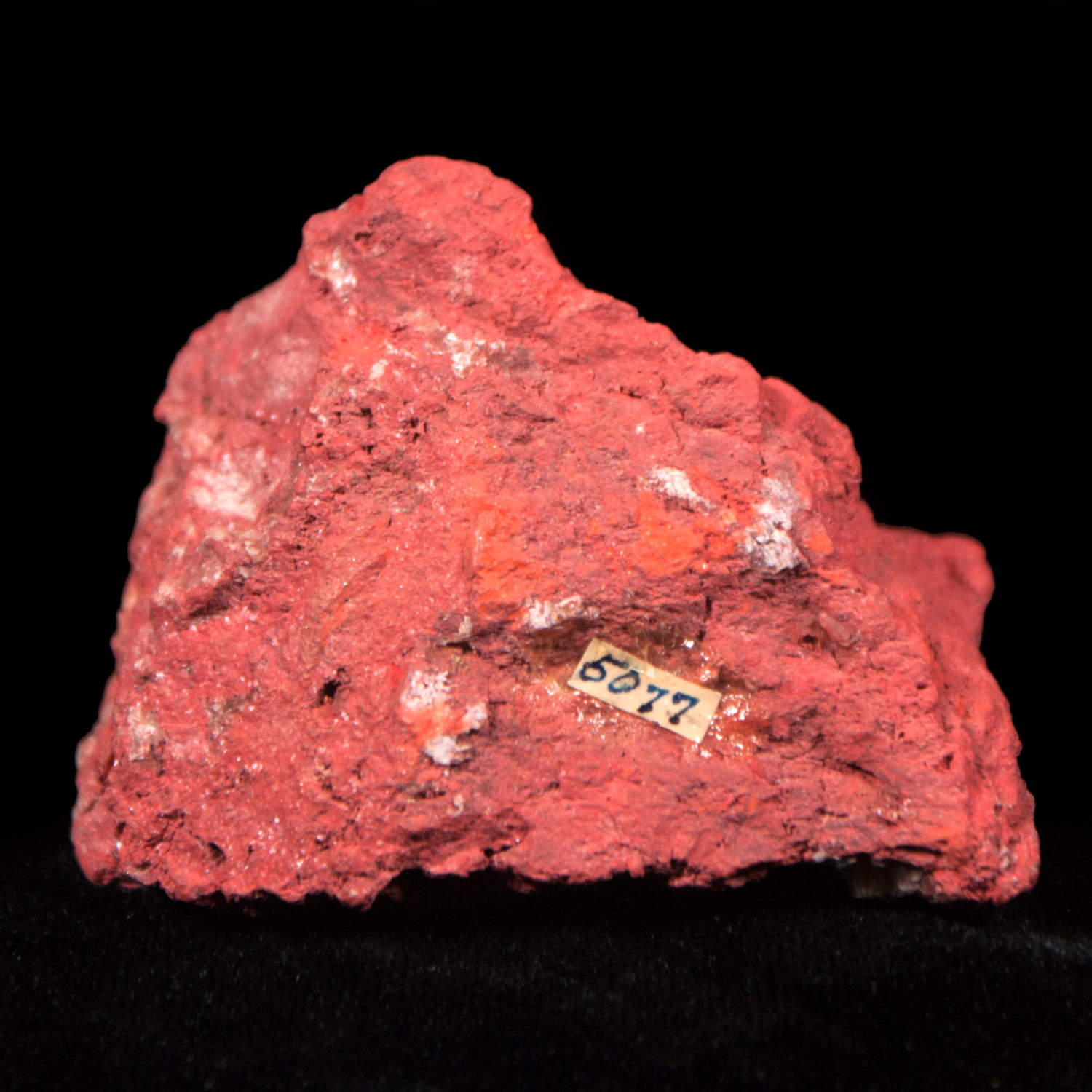 Cinnabar from Napa A sample of red cinnabar on a black background.