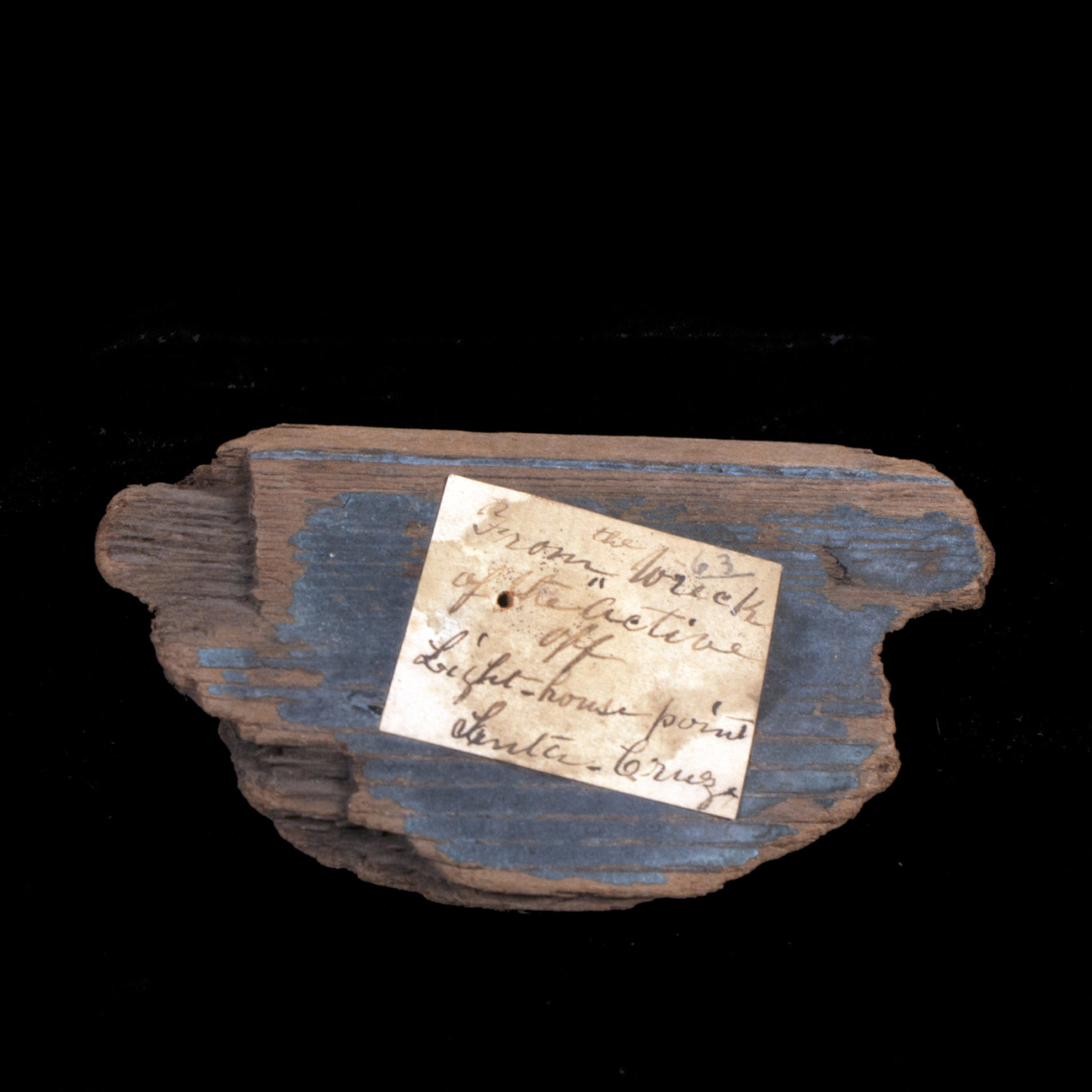 Wood from a shipwreck A piece of wood from a ship with a handwritten identification note on it.