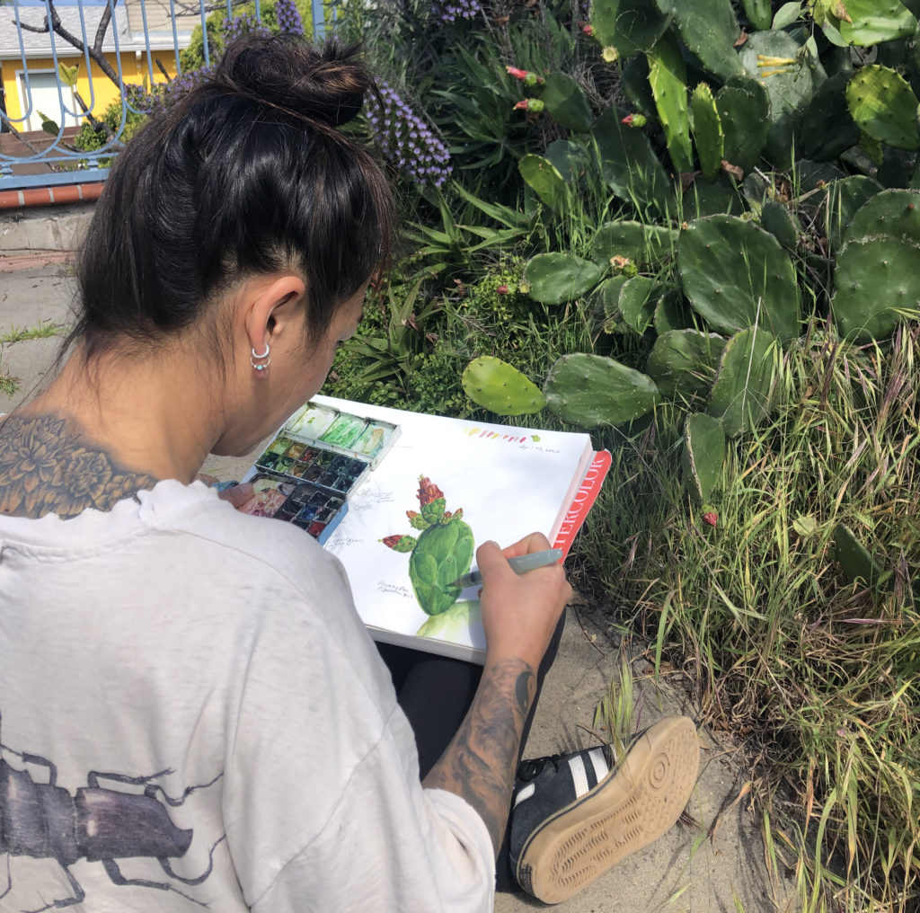 Yvonne Byers painting a watercolor of a cactus