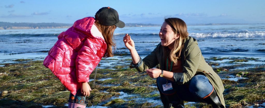 Marisa beachcombing with a young student