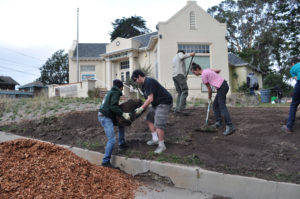 Ponderosa High students removing sod in preparation for native planting out front of the museum