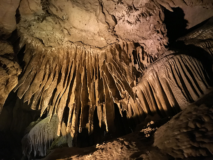 Photo of stalactite formations in a marble cave.