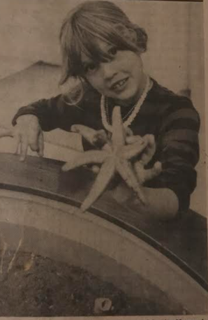 A black and white image of a girl holding up a sea star from a 1977 Sentinel article.