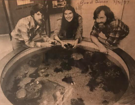 Museum staff in 1977 stand around the then new touch pool exhibit.