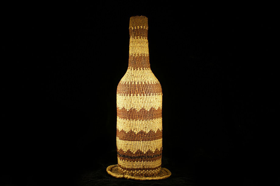 Glass bottle wrapped in basketry, made by the Klamath River Tribes