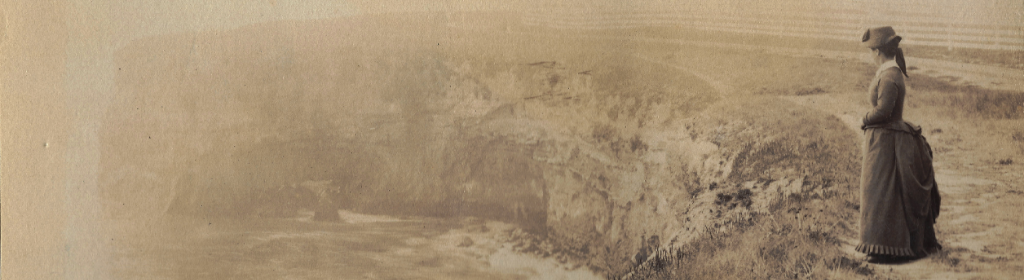 historic photograph of Laura Hecox standing along the coast